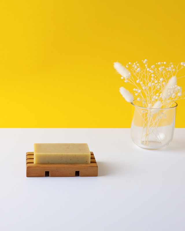 Soap with flowers on yellow background.